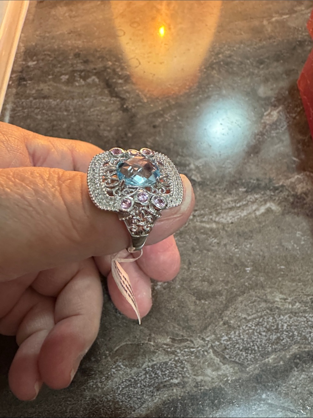Elegant Silver Ring with Light Blue Center Stone and Pink Accents